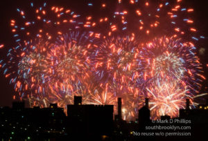 Macy's Fourth of July Fireworks fill the sky with fire above the city.